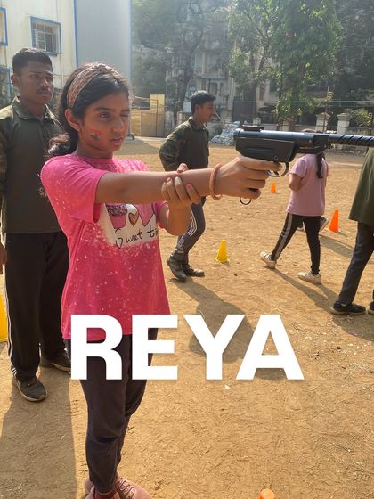 Reya showing great form and concentration during her turn at the pistol shooting range.