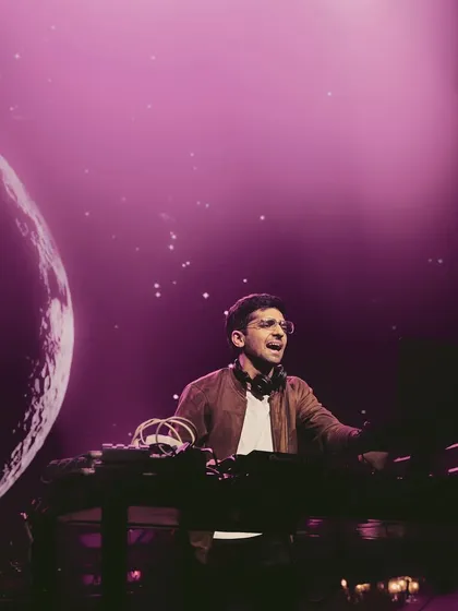 Lost in the music, creating a whole universe of sound. In this shot, you can see the visuals projecting a planet and starry sky behind me, matching the cosmic vibe of the set.