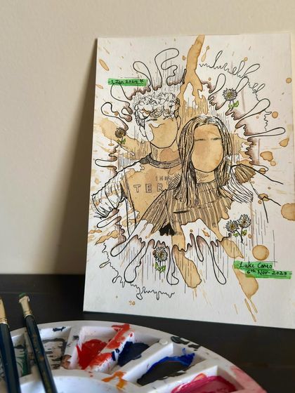 The unframed version of the coffee splash portrait, sitting on my desk with my paint palette. It gives a little behind-the-scenes look at my workspace.