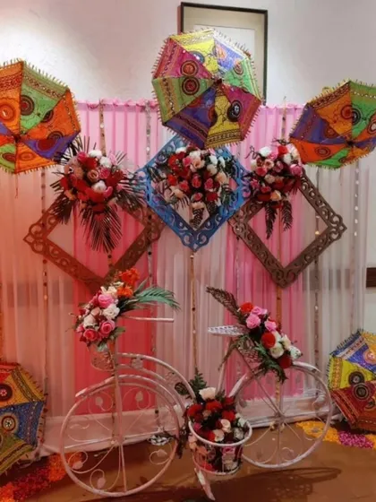 We love adding fun and unique props to your decor. This photo corner features a decorated bicycle and colourful Rajasthani umbrellas, creating a quirky and memorable spot for guests to take pictures.