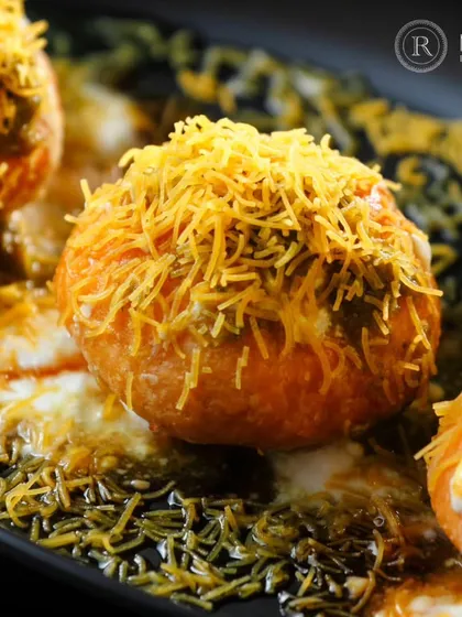We elevate classic street food into a gourmet experience. This close-up of our Dahi Raj Kachori, bursting with flavor and topped with crisp sev, is a perfect example of how we blend tradition with luxury for our exclusive chaat catering.