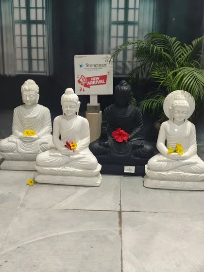Four distinct styles of our 2-foot Buddha statues, hand-carved from white and black marble, ready to bring serenity to your home.