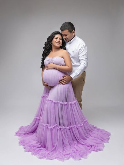 A full-length portrait of the couple, radiating happiness and love. The flowing lavender gown adds a touch of fairytale romance.