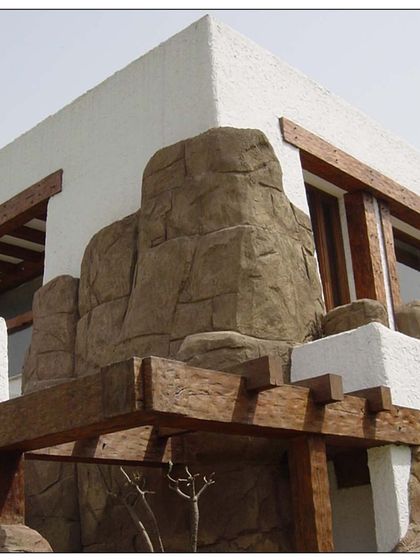 Embodying a river rock style in New Delhi, this private residence uses boulders and natural stone as a key exterior feature. This approach differentiates the home while gorgeously making it one with its surroundings.