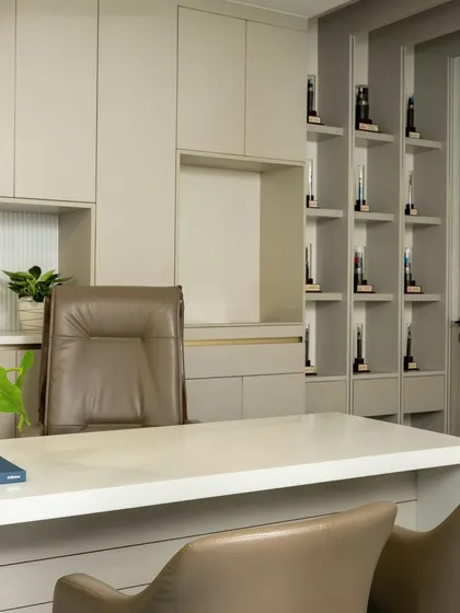This angle of the MD's cabin shows the seamless integration of the desk, chair, and bespoke shelving unit into a single, cohesive design statement.