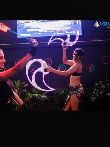Dancers with LED props performing alongside me.
