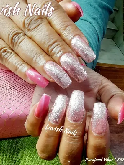 Extra-long square nails with a dramatic pink and silver glitter ombre effect.