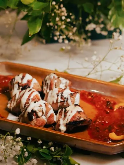 My Chicken Mullayam Kebab is a true masterpiece. The chicken is exceptionally tender and served on a bed of spicy red sauce with a cooling cream drizzle, creating a perfect balance of flavors.
