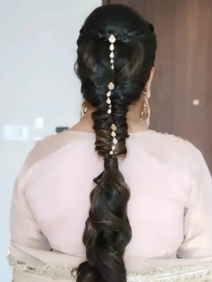 The back view of the long, voluminous bubble braid, adorned with delicate crystal accessories. I often use extensions to create extra length and thickness for this style.