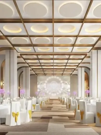 A 3D render of a premium banquet hall design. We can create exceptionally grand and modern spaces like this, with high ceilings, arched columns, and elegant table settings.