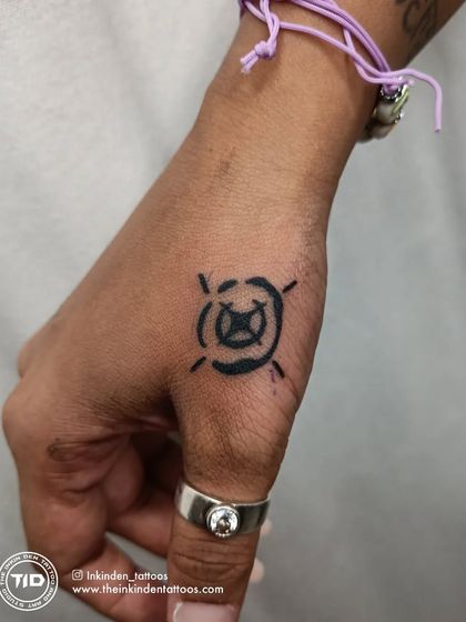 The Valorant 'Viper' ability icon tattooed on the thumb.