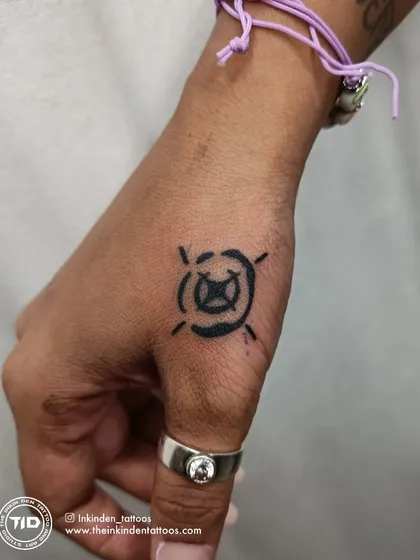 The Valorant 'Viper' ability icon tattooed on the thumb.