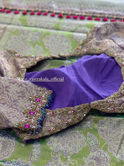 A purple blouse with brocade sleeves, featuring pink and blue stone work.