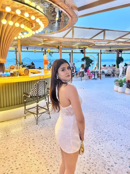 A look over the shoulder, capturing the beach view in the background.