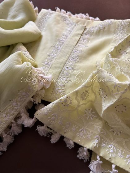 This image focuses on the intricate Chikankari and Mukesh work on the neckline and sleeves, complemented by hand-sewn tassels.