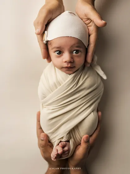 A slightly different angle from the same setup, showing the perfect, tiny form of the swaddled baby.