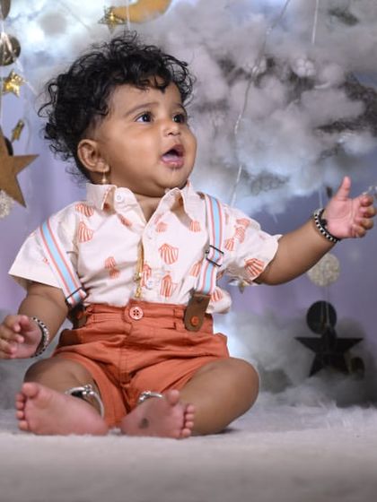 A candid moment of wonder in our celestial setup. The hanging stars and soft textures provide plenty of sensory interest for babies, leading to natural and curious expressions.