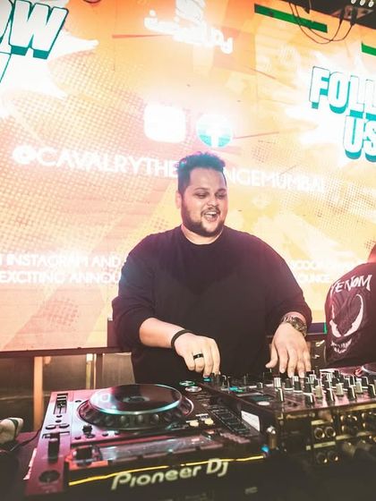 We are the party starters. A confident shot of me at the decks, ready to take the crowd on a musical journey.