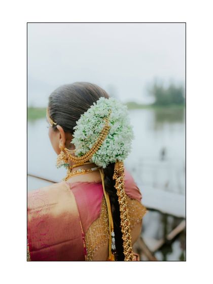 A detailed shot of the bride's traditional South Indian hairstyle, adorned with fresh flowers (gajra), an essential part of the bridal look.