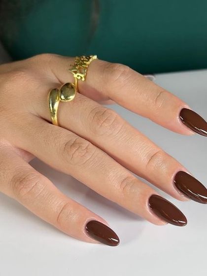 A rich, chocolate brown polish on long almond nails. This is a chic and trendy alternative to classic black or red.