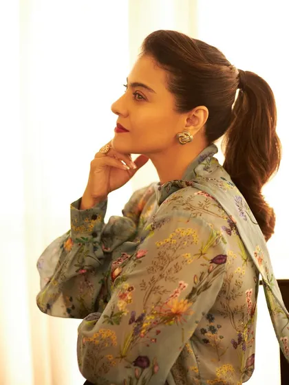 The side profile shows off the voluminous ponytail and the delicate details of the floral print.
