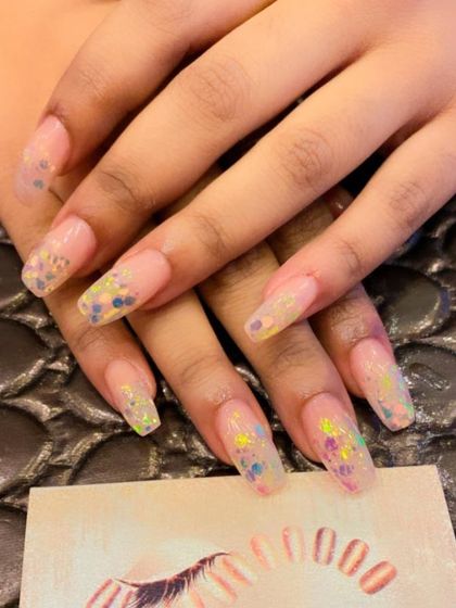 Long, clear coffin nails filled with colorful, chunky glitter flakes. This fun and playful design looks like confetti on your fingertips.