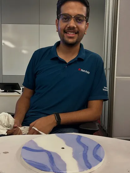 A NetApp employee with his finished resin clock, showing another unique design. No two pieces ever turn out the same.