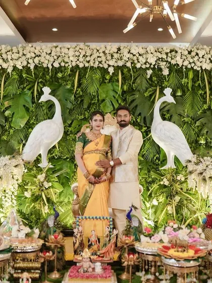 It's a joy to see couples surrounded by the beauty of their celebration. Here, I designed a lush green peacock-themed backdrop and a full traditional plate display for a memorable baby shower.