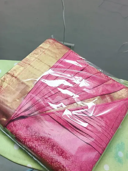 A ready-to-wear pre-pleated saree, packed and waiting for the client. This service is perfect for ensuring a flawless look for any event.