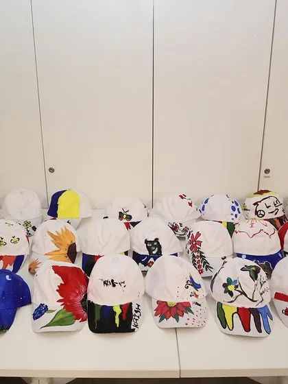 A closer look at the amazing, colorful caps painted by the kids during the HBC workshop. Their imagination truly has no limits.
