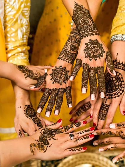 A beautiful photo showcasing the intricate and matching mehndi designs of the bride and her bridesmaids. This shot captures the spirit of friendship and shared celebration.