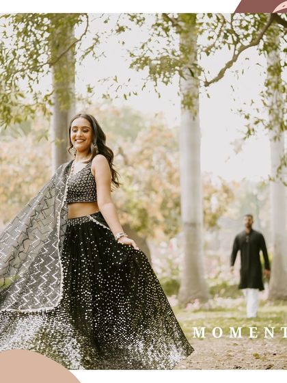 A beautiful candid shot of the bride-to-be twirling in her sparkling lehenga, with her partner in the background, creating a dreamy and cinematic moment in the park.