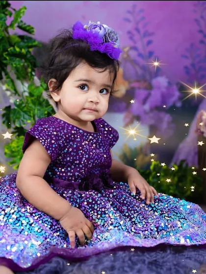 A serene portrait of the birthday girl in her shimmering dress. The added star effects give this photo an extra touch of magic.