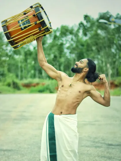 The Chenda is heavy, but our passion makes us strong. This pose is a tribute to the physical strength and dedication this art form demands.