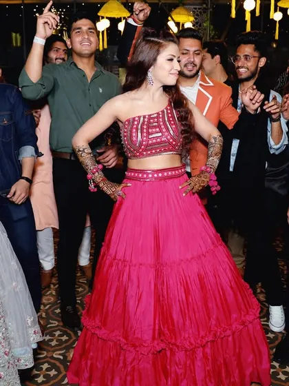 The bride-to-be owning the dance floor at her Sangeet. I capture these moments of pure joy and confidence, surrounded by friends and family.