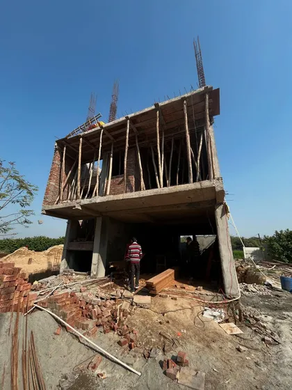 A residential building mid-construction, with the concrete structure fully cast. This raw stage, known as the RCC frame, is the skeleton of the home, and its strength is our top priority.