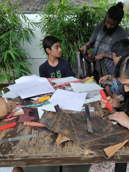 Participants of all ages engaged in our leathercraft workshop. The process of cutting, shaping, and stitching leather is a focused, hands-on activity that everyone can enjoy.