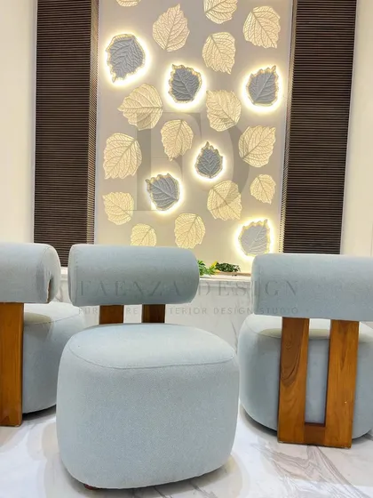 This shows custom-designed low seating for a serene home mandir. The chairs, upholstered in a light blue fabric with solid wood bases, are crafted to be both beautiful and appropriate for a sacred space.