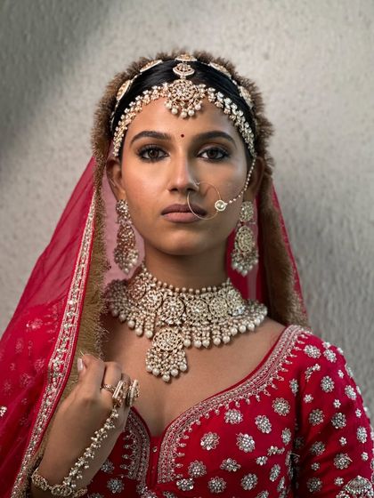 A powerful and intense portrait, showcasing the beauty of dusky skin with bold, traditional styling.