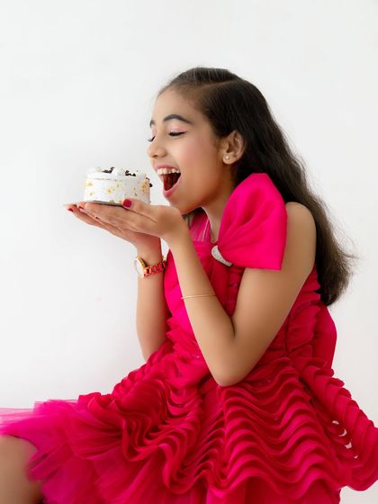 It's time to eat the cake. A fun shot capturing the birthday girl's excitement as she goes for a big bite.