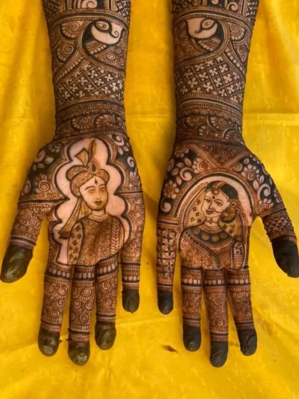 For this bride, we blended the worlds of Mangalore and Mumbai. The design features portraits of the couple in traditional attire on the palms, with the skylines of their home cities on each arm, telling the story of where they come from and the new life they are building together.