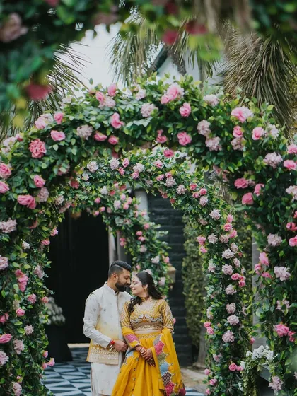 A simple moment becomes magical under a lush floral archway. I designed this entrance with hundreds of pink roses and greenery to create a romantic, garden-like feel, perfect for couple portraits and welcoming guests into the celebration.