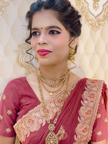 A simple and graceful look for a family function. The makeup is minimal and clean, paired with a classic multi-layered necklace and a neat hairstyle.