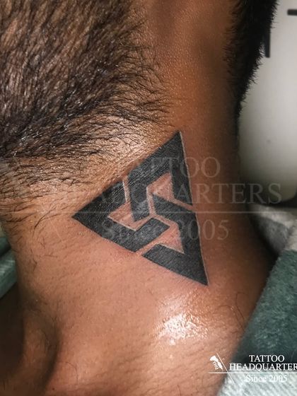 A geometric triangle symbol tattooed on the side of the neck, a sharp and modern design.