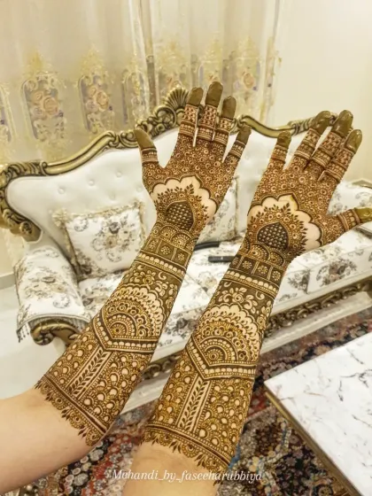 The full view of the arms, showcasing the symmetry and grandeur of the bridal design.