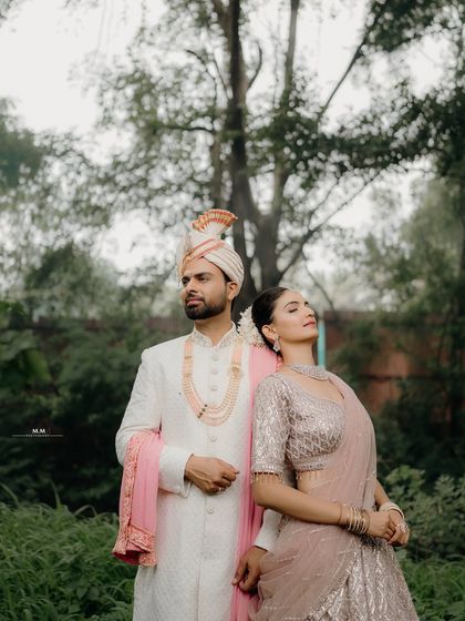 A stylish and confident pose in a natural setting. This portrait showcases their elegance and poise as a couple, ready to step into their future together.