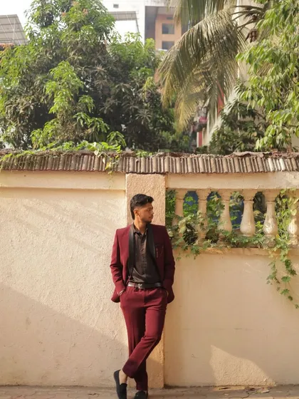 A deep maroon suit is a fantastic choice for an evening event. This client looks stylish and sophisticated in our rental, perfect for a wedding reception or a sangeet.