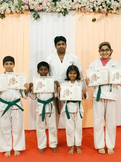 These students have just been awarded their green belts, a significant milestone in their karate training. Their hard work in mastering kihon, kata, and kumite has paid off.