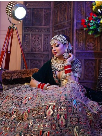 A breathtaking shot of a bride in a multi-colored, heavily embroidered lehenga. The wide flare of the skirt shows the grandeur of the outfit, perfect for a royal bridal entry.