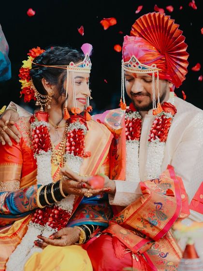 A close-up of the couple during a wedding ritual, their faces lit with smiles as they share a moment of connection.